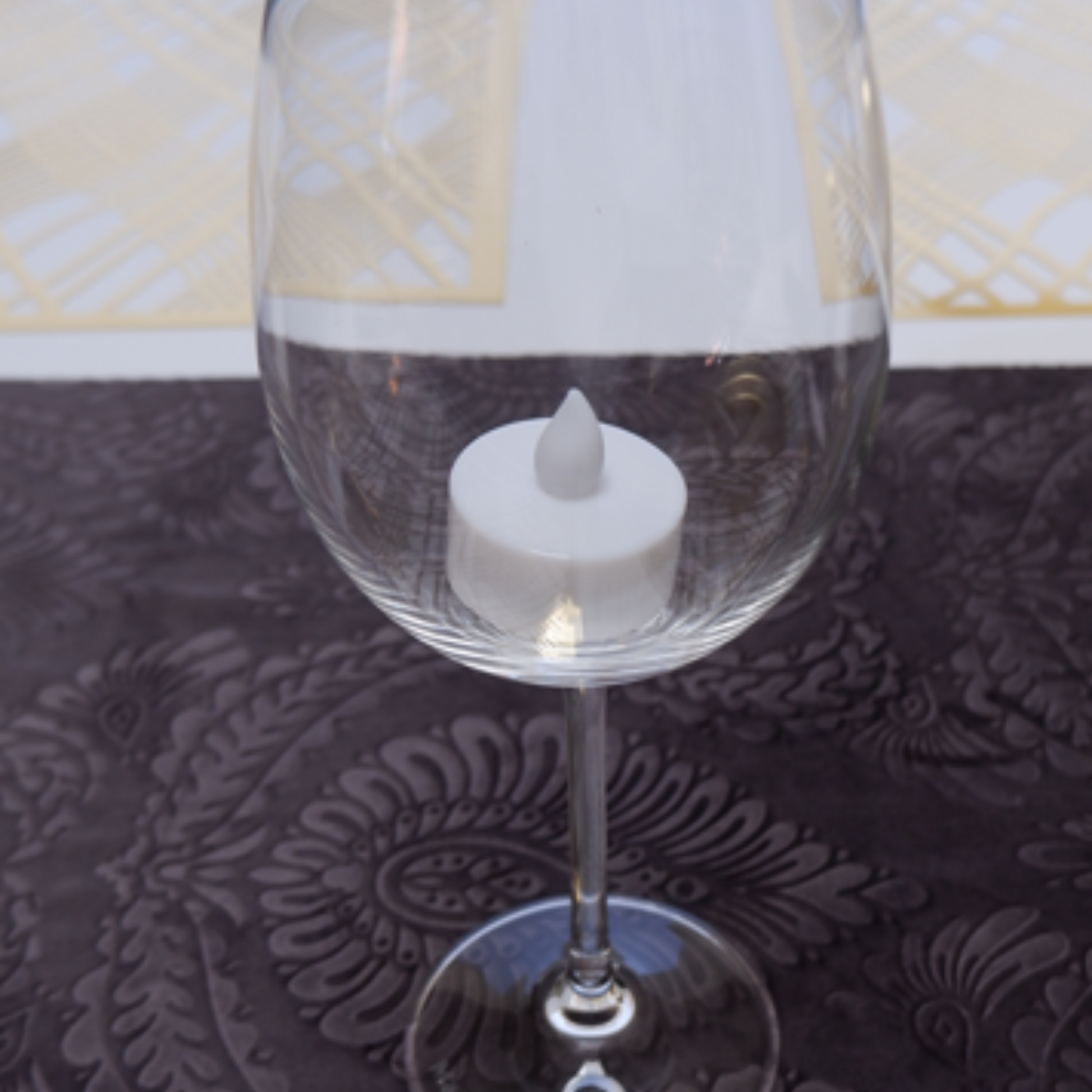 Battery operated light inside the wine glass then just top with the lamp shade. For Decorative purposes only